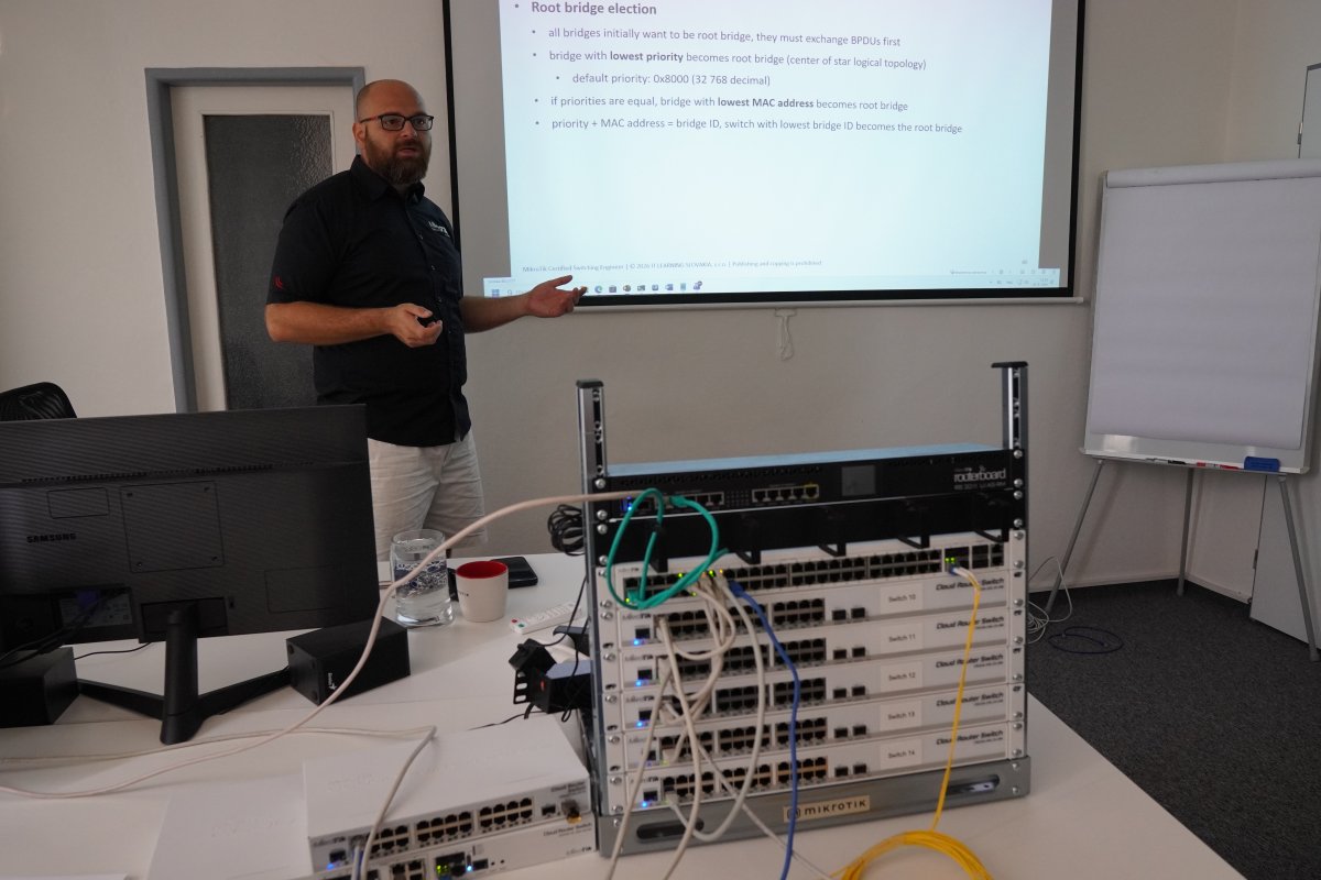 Priebeh kurzu MikroTik MTCSWE - výuková učebňa s konfiguráciou sieťových switchov a káblov, prezentácia root bridge election